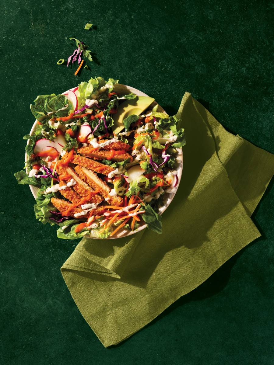 Buffalo chikn patty cut up in a salad.