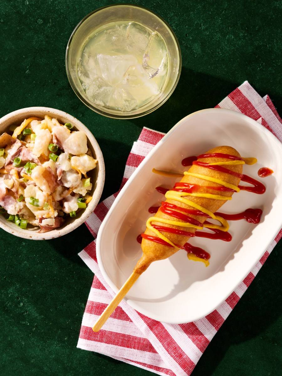 Corn dog on a plate.